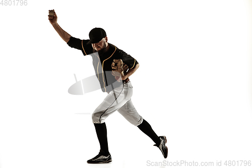 Image of Baseball player, pitcher in a black uniform practicing on a white background.