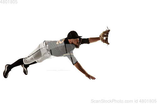 Image of Baseball player, pitcher in a black uniform practicing on a white background.