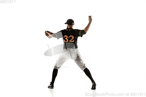 Image of Baseball player, pitcher in a black uniform practicing on a white background.