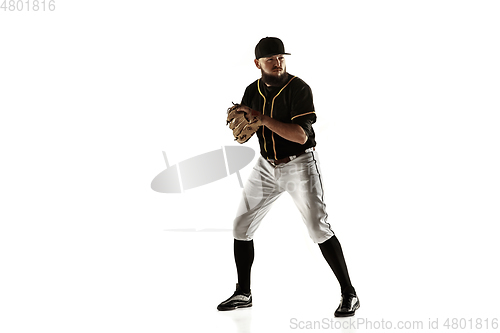 Image of Baseball player, pitcher in a black uniform practicing on a white background.