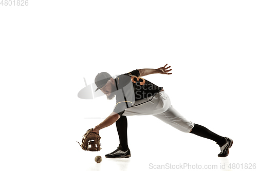 Image of Baseball player, pitcher in a black uniform practicing on a white background.