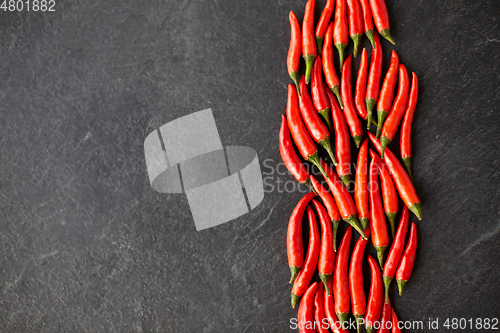 Image of red chili or cayenne pepper on slate stone surface