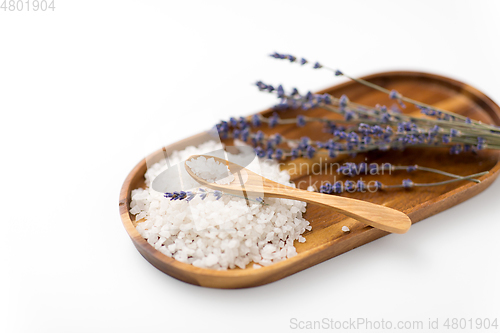 Image of sea salt heap, lavender and spoon on wooden tray