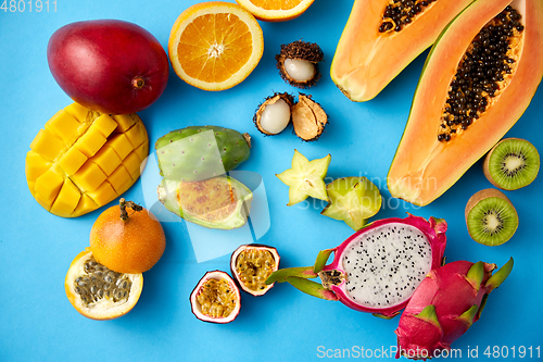 Image of different exotic fruits on blue background