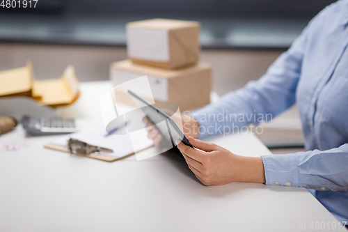 Image of close up of woman with tablet pc at post office