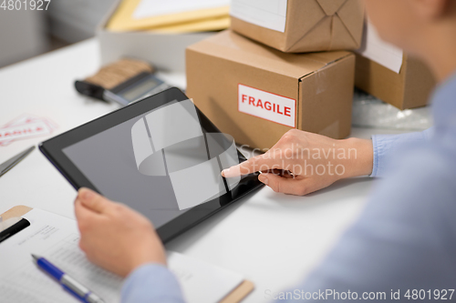 Image of hands with tablet pc and clipboard at post office