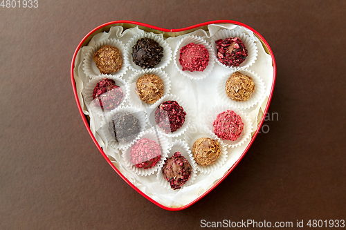 Image of candies in red heart shaped chocolate box