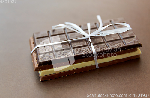 Image of different kinds of chocolate on brown background