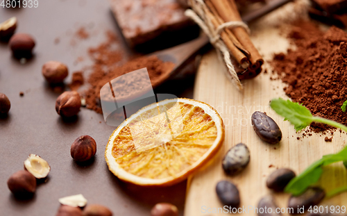 Image of chocolate with hazelnuts, cocoa beans and orange