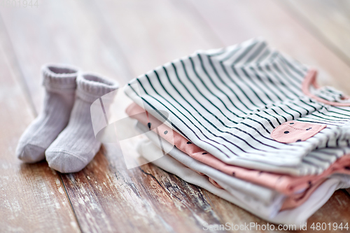 Image of close up of baby clothes on wooden table