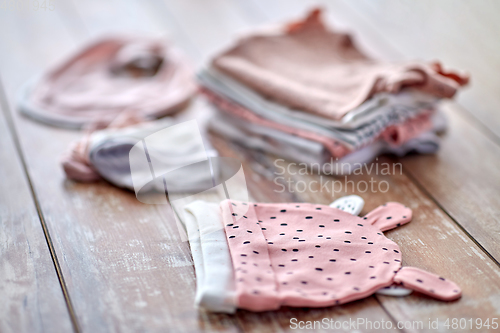 Image of close up of baby clothes on wooden table