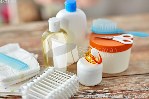 Image of baby accessories for bathing on wooden table