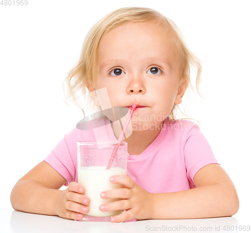 Image of Cute little girl with a glass of milk