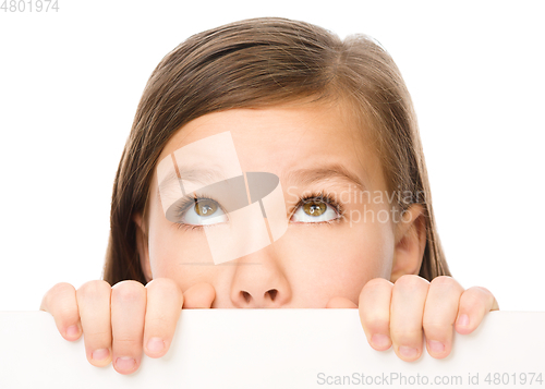 Image of Little girl is looking from out blank board