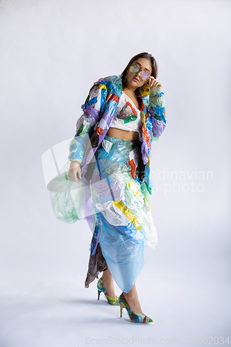 Image of Woman addicted of sales and clothes, wearing plastic, recycling concept