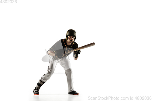 Image of Baseball player, pitcher in a black uniform practicing on a white background.