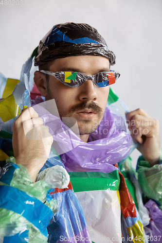 Image of Man addicted of sales and clothes, wearing plastic, recycling concept