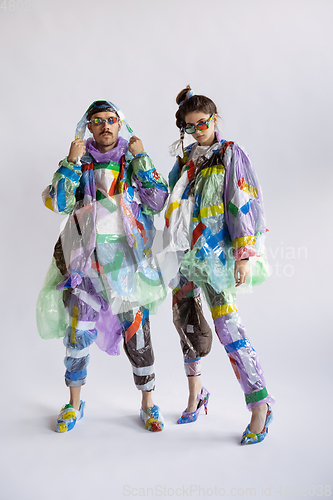 Image of Woman and man addicted of sales and clothes, wearing plastic, recycling concept