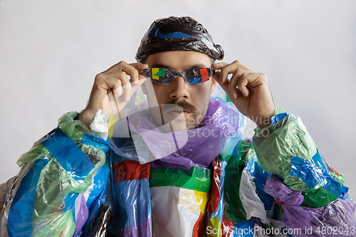 Image of Man addicted of sales and clothes, wearing plastic, recycling concept