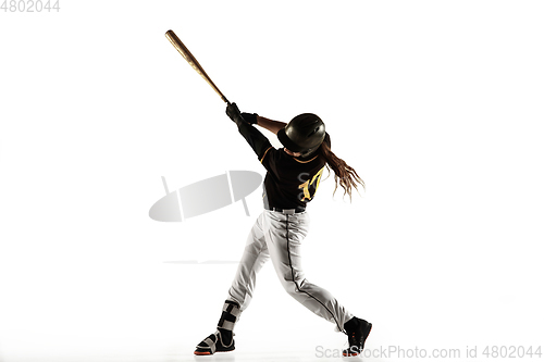 Image of Baseball player, pitcher in a black uniform practicing on a white background.