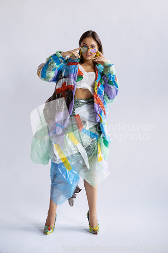 Image of Woman addicted of sales and clothes, wearing plastic, recycling concept