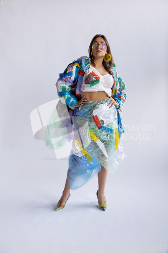 Image of Woman addicted of sales and clothes, wearing plastic, recycling concept