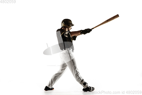 Image of Baseball player, pitcher in a black uniform practicing on a white background.