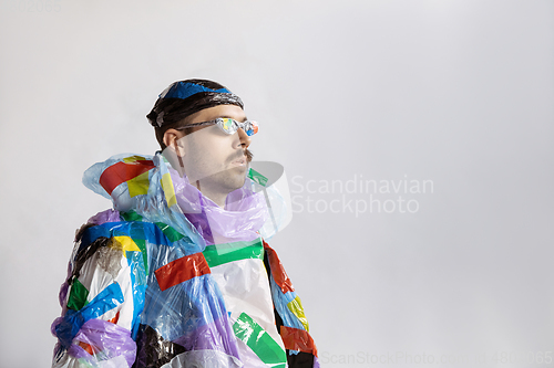 Image of Man addicted of sales and clothes, wearing plastic, recycling concept