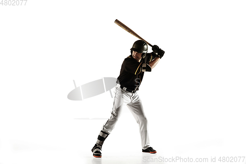 Image of Baseball player, pitcher in a black uniform practicing on a white background.