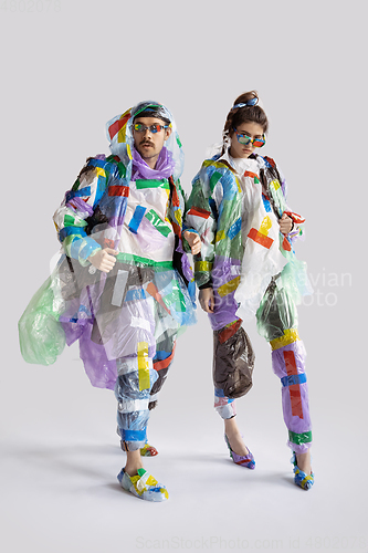 Image of Woman and man addicted of sales and clothes, wearing plastic, recycling concept