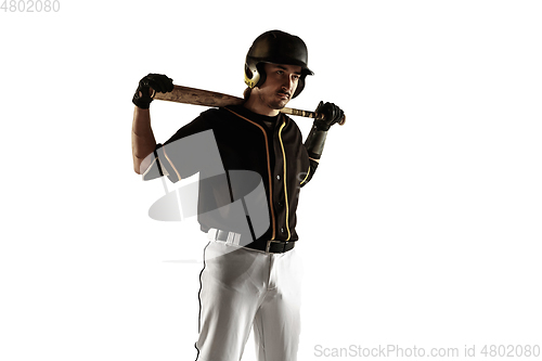 Image of Baseball player, pitcher in a black uniform practicing on a white background.