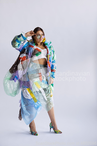 Image of Woman addicted of sales and clothes, wearing plastic, recycling concept