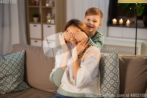 Image of happy smiling mother playing with her son at home