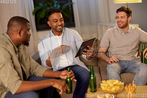 Image of male friends with tablet pc drinking beer at home