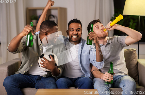 Image of friends or soccer fans with ball and beer at home