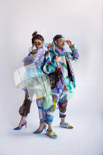 Image of Woman and man addicted of sales and clothes, wearing plastic, recycling concept