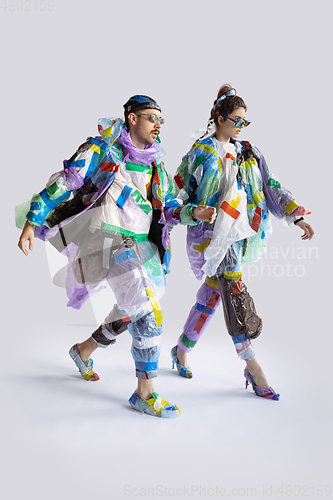 Image of Woman and man addicted of sales and clothes, wearing plastic, recycling concept