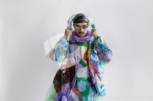 Image of Man addicted of sales and clothes, wearing plastic, recycling concept