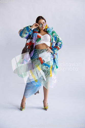 Image of Woman addicted of sales and clothes, wearing plastic, recycling concept