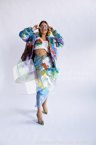 Image of Woman addicted of sales and clothes, wearing plastic, recycling concept