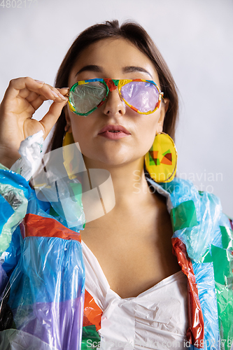 Image of Woman addicted of sales and clothes, wearing plastic, recycling concept