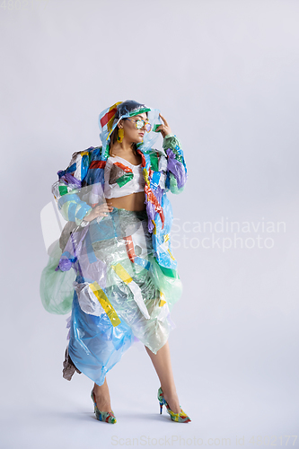 Image of Woman addicted of sales and clothes, wearing plastic, recycling concept