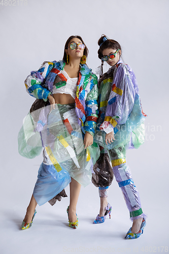 Image of Women addicted of sales and clothes, wearing plastic, recycling concept