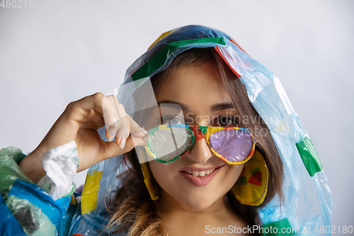 Image of Woman addicted of sales and clothes, wearing plastic, recycling concept