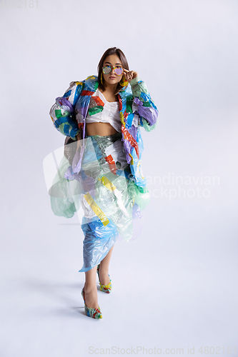 Image of Woman addicted of sales and clothes, wearing plastic, recycling concept