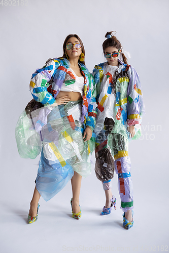 Image of Women addicted of sales and clothes, wearing plastic, recycling concept