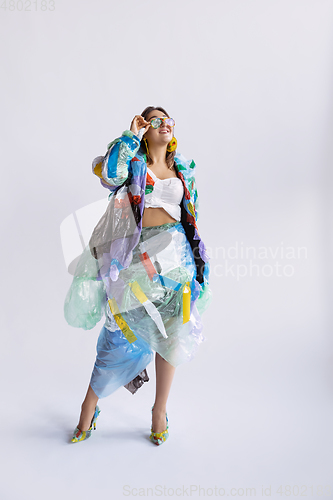 Image of Woman addicted of sales and clothes, wearing plastic, recycling concept