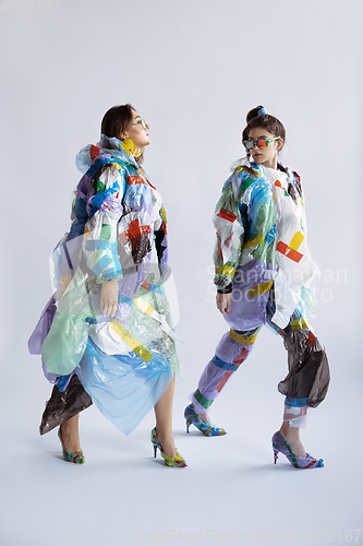 Image of Women addicted of sales and clothes, wearing plastic, recycling concept