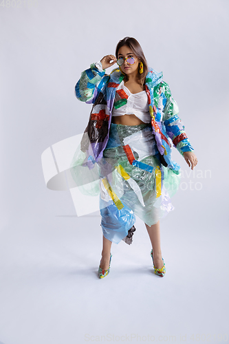 Image of Woman addicted of sales and clothes, wearing plastic, recycling concept