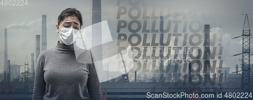 Image of Caucasian woman wearing the respiratory protection mask against air pollution and dusk with factories on background